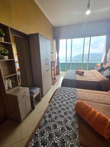 a bedroom with two beds and a view of the ocean at Polo Region Rest Inn in Haputale +31 photos