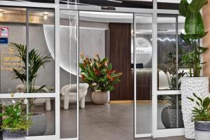 a lobby with potted plants in a room at Boutique Hotel Opal ULTRA ALL INCLUSIVE in Sunny Beach +48 photos