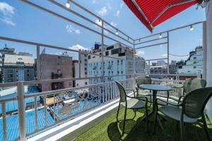 a balcony with chairs and a table on a building at From H Dongbaek Hotel by Kwon Gohyeon in Geoje