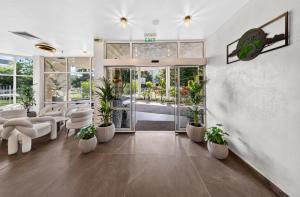 a living room with white furniture and potted plants at Boutique Hotel Opal ULTRA ALL INCLUSIVE in Sunny Beach