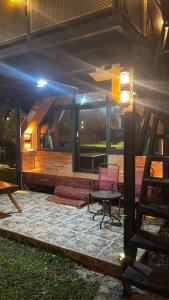 a house with a patio with a table and a chair at Cluster Romantic Superior in Cicadas