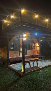 a house with a picnic table in the yard at night at Cluster Romantic Superior in Cicadas +2 photos