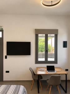 a room with a table with a laptop on it at Ovio II in Kampos Paros