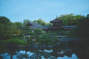 a pagoda in the middle of a garden with a pond at The Villa Nene-no-Michi Kazeno Heritage formerly HOTEL VMG RESORT KYOTO Nene in Kyoto