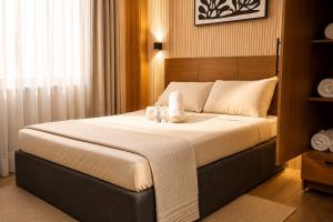 a bedroom with a large bed with towels on it at Casa Andrea Bukidnon in Impasugong