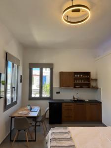 a kitchen with a table and a table and chairs at Ovio II in Kampos Paros
