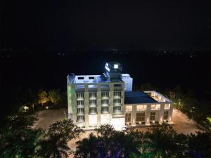 a building with a light on top of it at night at Hotel The Nature Regency in Satara