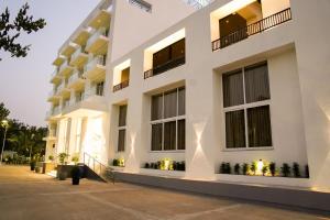 a facade of a building at night at Hotel The Nature Regency in Satara