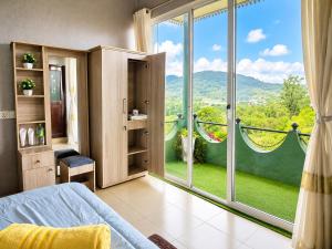 a bedroom with a large window with a view at Polo Region Rest Inn in Haputale