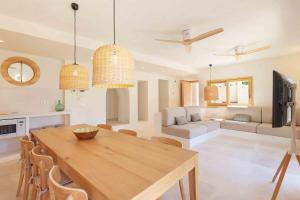 a kitchen and living room with a wooden table and chairs at Sa Font in Puigpunyent