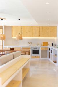 a kitchen with a couch and a table at Sa Font in Puigpunyent