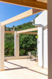 a view from the deck of a house with a large window at Sa Font in Puigpunyent