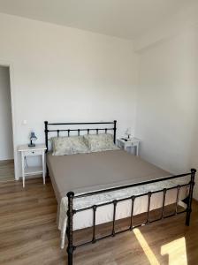 a bedroom with a large bed in a room at Rosalie Home - Aegean Poseidon in Tinos