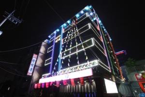 a large building with lights on it at night at Hotel I Chuncheon Branch in Chuncheon