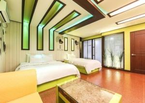 two beds in a room with green lights on the ceilings at Hotel I Chuncheon Branch in Chuncheon +5 photos