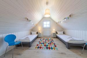 a room with two beds and a rug in a attic at Ferienhaus Hafenoase in Wandlitz +70 photos