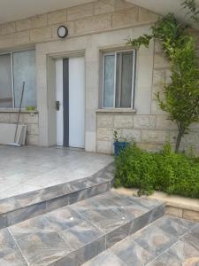 a house with a stone steps leading to a door at Home Star 2 in Dāliyat el Karmil