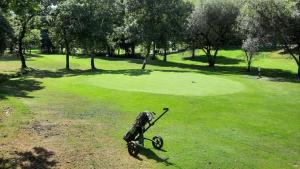 a toy on a bike on a golf course at Apartamento playa in Boiro