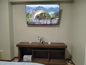 a painting hanging on a wall above a table at Alojamiento Wanka in Huancayo