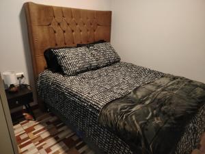 a bedroom with a bed with a pillow on it at Alojamiento Wanka in Huancayo
