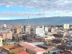 a city with buildings and mountains in the background at Alojamiento Wanka in Huancayo +3 photos