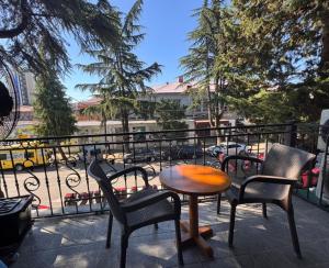 a patio with chairs and a table on a balcony at Antika Hotel in Batumi