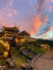 a lit up building with lights in front of it at Đồi Ông Thoại Cottage in Bảo Lộc