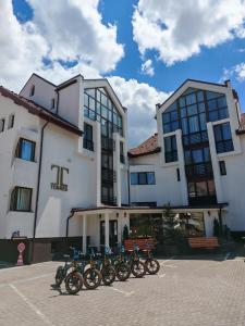 a row of motorcycles parked in front of a building at Torres Poiana Boutique in Poiana Brasov