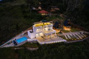 an aerial view of a white house with a swimming pool at Green Infinity Resorts in Diyatalawa