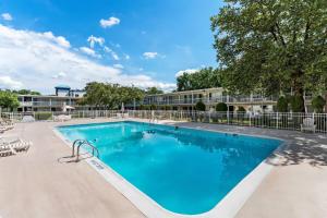 a swimming pool at a resort with a building in the background at Howard Johnson by Wyndham Albany in Albany