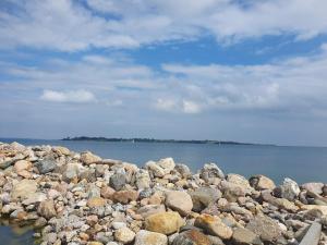 a pile of rocks next to the water at 4 person holiday home in Aabenraa in Aabenraa +23 photos