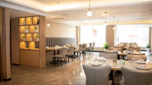 a dining room with a long table and chairs at Jiuding Joy Hotel in Kathmandu