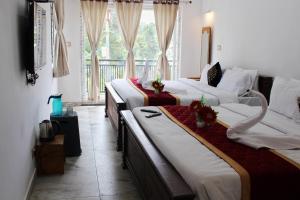 a living room with two beds and a couch at Altiora Homestay in Kodaikānāl