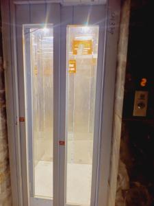 a room with a glass door in a building at Hotel Shree krishna in Ujjain