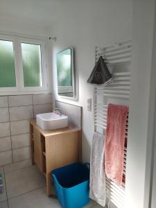 a bathroom with a sink and a mirror at Lénola en Ardèche in Labeaume