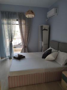 a large bed in a room with a window at Dream house steps from sea in Pídima Kyrás +4 photos