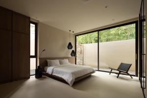 a bedroom with a bed and a large window at KW3 Villas in Mae Nam +25 photos