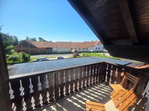 a solarium on a balcony with two chairs at Apartmaji Picasso Design in Veržej