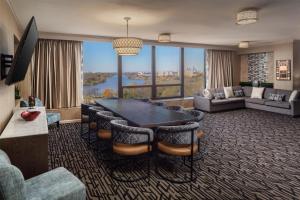 a large living room with a table and chairs at DoubleTree by Hilton Cherry Hill Philadelphia in Cherry Hill