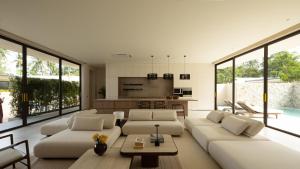 a living room with white furniture and large windows at KW3 Villas in Mae Nam