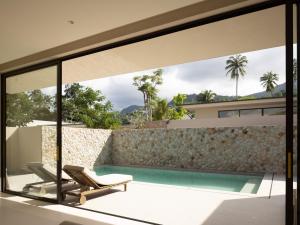 a view of the pool from the balcony of a house at KW3 Villas in Mae Nam