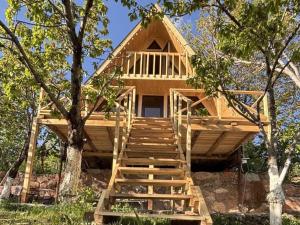 a tree house with stairs leading up to it at Byurakan Cottages in Antarut