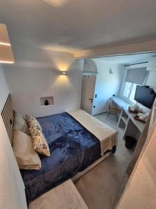 a bedroom with a large bed and a desk at Apomero Apartment in Rochari Panormos in Panormos