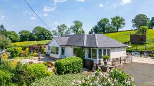 a small white house in a garden at The Bay Tree Bed & Breakfast in Alton