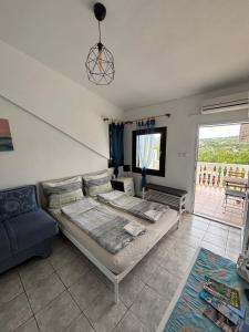 a living room with a bed and a couch at Villa Alexa Cesarica in Cesarica