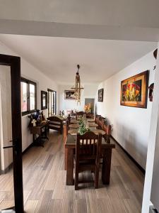 a dining room and living room with a table and chairs at Casa Mura in San Lorenzo El Cubo +28 photos
