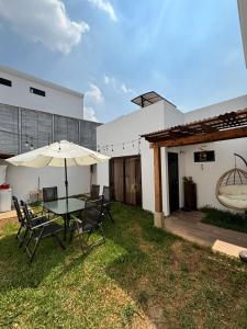 a patio with a table and chairs and an umbrella at Casa Mura in San Lorenzo El Cubo