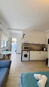 a kitchen and living room with a couch and a table at Studio 87 in Rhodes Town