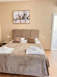 a bedroom with a bed with two towels on it at Villa Hercegovački raj Elf in Blagaj +17 photos
