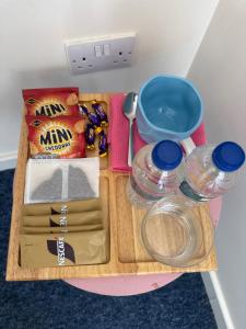 a cutting board with food and other items on it at Bambi Nest in Sketty